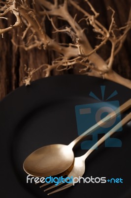 Black Empty Plate Fork Spoon On Wooden Table Background Stock Photo