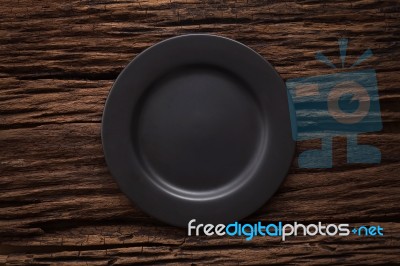 Black Empty Plate On Wooden Table Background Stock Photo