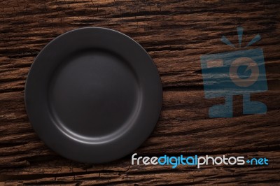 Black Empty Plate On Wooden Table Background Still Life Stock Photo