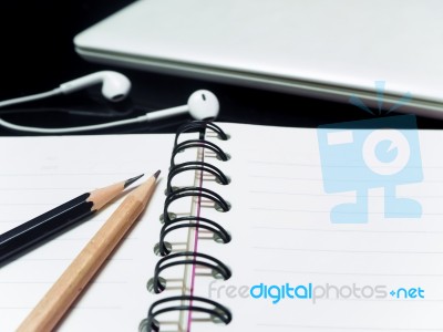 Black Pencil And Wooden Pencil And Book Hoop On The Teble Stock Photo