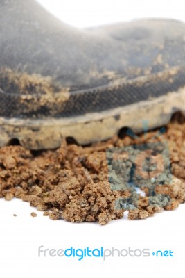 Black Rubber Boot And Soil On White (close-up) Stock Photo