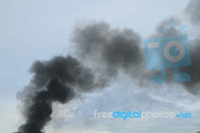 Black Smoke From Fire Burning On The Sky Stock Photo