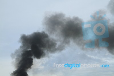 Black Smoke From Fire Burning On The Sky Stock Photo