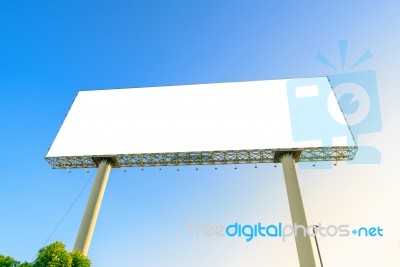 Blank Billboard At Blue Sky Background, Mock Up With Flare Stock Photo