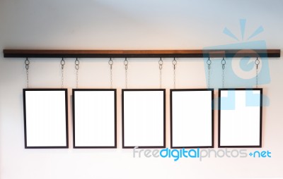 Blank Boards Hanging On White Wall Background Stock Photo