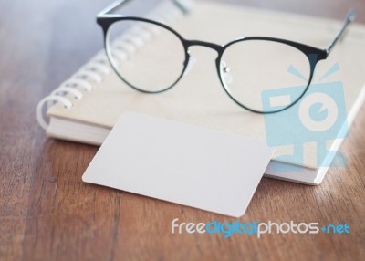 Blank Business Cards And Eyeglasses On Wooden Table Stock Photo