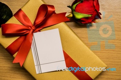 Blank Card On Ribbon Gift Box And Red Rose Stock Photo