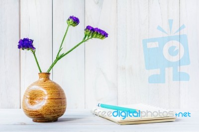 Blank Notebook With Flower On White Wooden Table Stock Photo