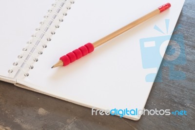 Blank Notebook With Pencil On Grey Background Stock Photo