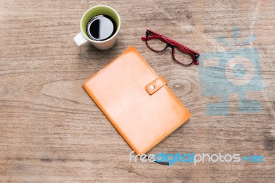 Blank Orange Leather Diary,glasses And A Cup Of Coffee Stock Photo