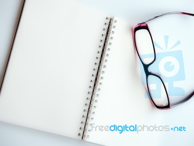 Blank Page Of A Notebook And Eyeglasses Stock Photo