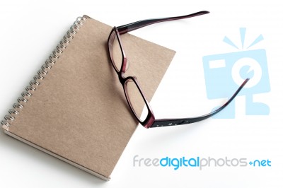 Blank Page Of A Notebook And Eyeglasses Stock Photo