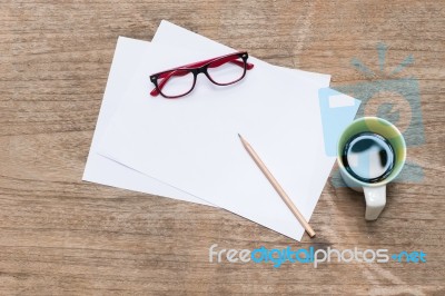 Blank Paper With Pencil A Cup Of Coffee And Eye Glasses Stock Photo