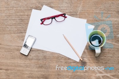 Blank Paper With Pencil A Cup Of Coffee Mobile Phone And Eye Glasses Stock Photo