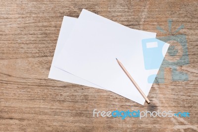 Blank Paper With Pencil On Wood Table Stock Photo