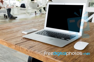 Blank Screen Laptop Computer On Wood Table Stock Photo