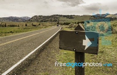 Blank Sign With Arrow Head Along The Country Road Stock Photo