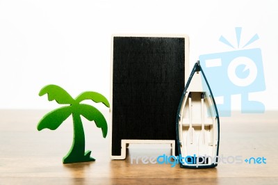 Blank Wooden Black Board With Green Palm Tree And White Boat Stock Photo