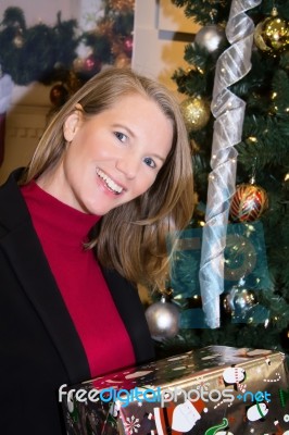 Blonde Female Looking At Camera Holding Presents Stock Photo