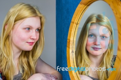 Blonde Girl Looking In Mirror Stock Photo