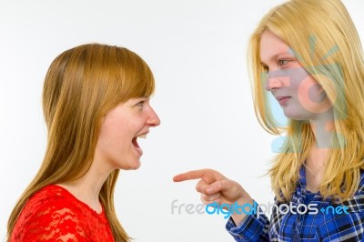 Blonde Girl Pointing At Redhead Girlfriend Stock Photo