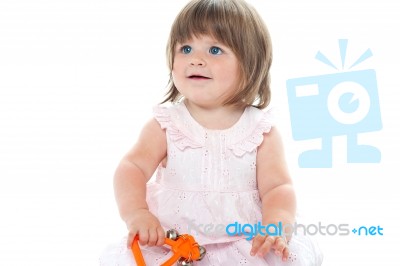 Blonde Infant Playing With A Rattle Stock Photo