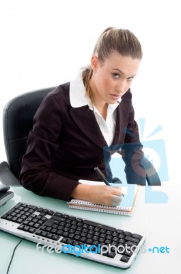 Blonde Professional Writing On Notebook Stock Photo