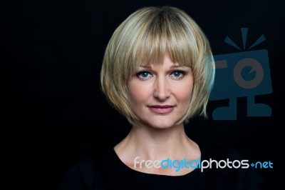 Blonde Woman Isolated Against Black Background Stock Photo