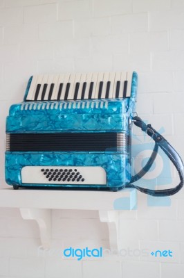 Blue Accordion In White Room Stock Photo