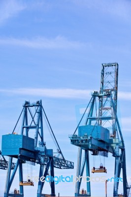 Blue Cargo Cranes At Sea Port Stock Photo