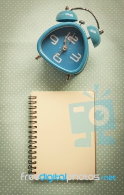 Blue Clock And Blank Notebook Stock Photo