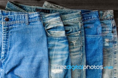 Blue Jean And Jean Lack Texture On The Wooden Floor Stock Photo