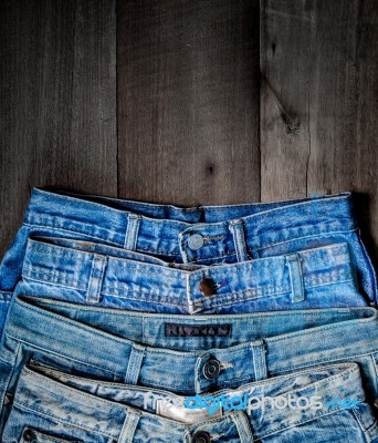 Blue Jean And Jean Lack Texture On The Wooden Floor Stock Photo