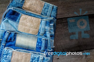 Blue Jean And Jean Lack Texture On The Wooden Floor Stock Photo