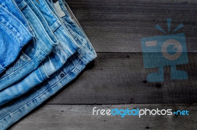 Blue Jean And Jean Lack Texture On The Wooden Floor Stock Photo