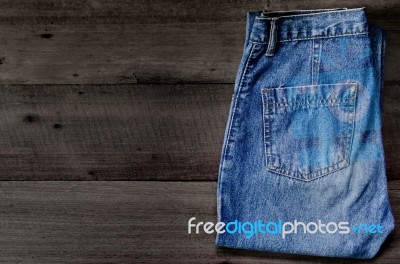 Blue Jean And Jean Lack Texture On The Wooden Floor Stock Photo