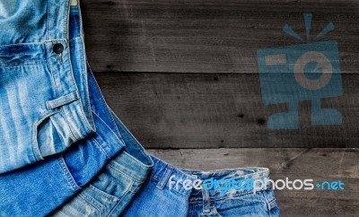 Blue Jean And Jean Lack Texture On The Wooden Floor Stock Photo