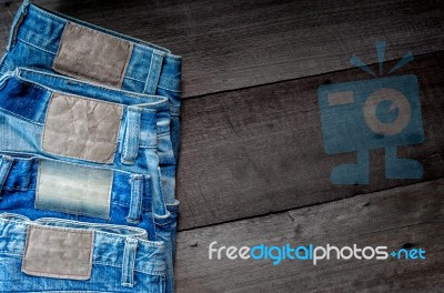 Blue Jean And Jean Lack Texture On The Wooden Floor Stock Photo