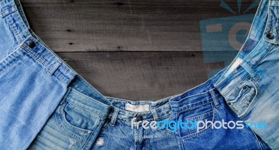 Blue Jean And Jean Lack Texture On The Wooden Floor Stock Photo