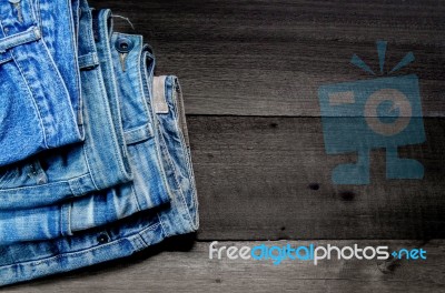 Blue Jean And Jean Lack Texture On The Wooden Floor Stock Photo