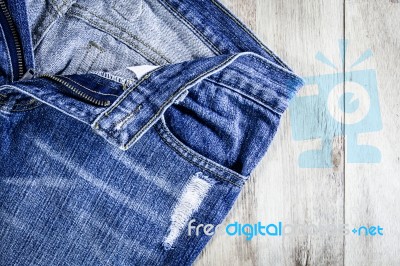 Blue Jeans On Old Wooden Background Stock Photo