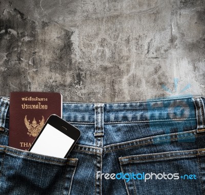 Blue Jeans With Cell Phone And Passport In A Pocket Background Stock Photo