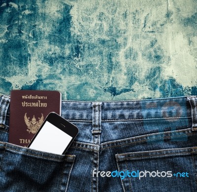 Blue Jeans With Cell Phone And Passport In A Pocket Background Stock Photo