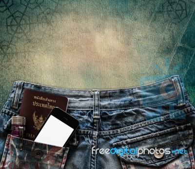 Blue Jeans With Cell Phone, Flashlight And Passport In A Pocket Stock Photo