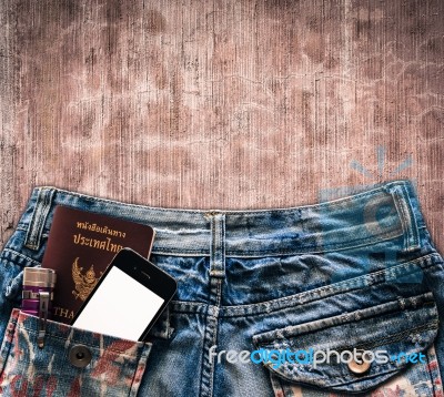 Blue Jeans With Cell Phone, Flashlight And Passport In A Pocket Stock Photo