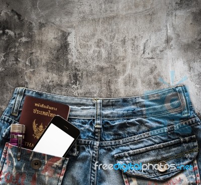 Blue Jeans With Cell Phone, Flashlight And Passport In A Pocket Stock Photo