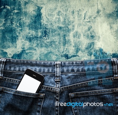 Blue Jeans With Cell Phone, Flashlight And Passport In A Pocket Stock Photo