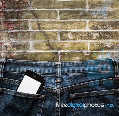 Blue Jeans With Cell Phone In A Pocket Background Stock Photo