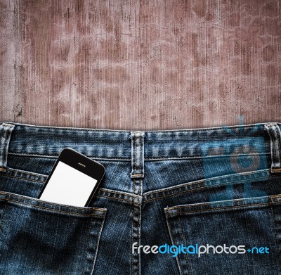 Blue Jeans With Cell Phone In A Pocket Background Stock Photo