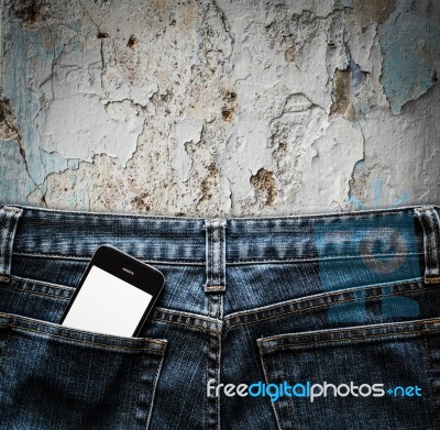 Blue Jeans With Cell Phone In A Pocket Background Stock Photo